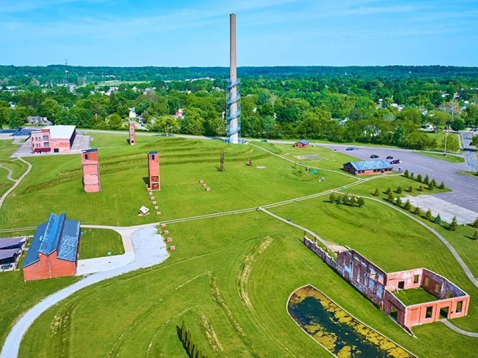 ariel-foundation-park-wide-shot-destroyed-factory-buildings-walking-paths-aerial